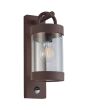 Trio Sambesi 204169124 roestbruine wandlamp voor buiten met een rechthoekige wandplaat en hangende cilindervormige kap met bewegingsmelder