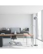 Sfeerfoto van Trio Ackbar staalkleurige uplighter van 182,5 cm hoog met leeslamp en kantelbare uplighter in een kantoorkamer naast een bureau