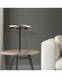 Searchlight Aerial EU 62331GO sfeerfoto van tafellamp van 35cm hoog in zwart met goudkleur en cirkelvormig kap met LED ring op een bijzettafel naast een witte bank
