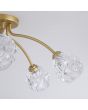 Searchlight Astral 11525-5GO detailfoto van twee armen met glazen kap van de goudkleurige plafondlamp met vijf armen met elk een glazen kap met structuur