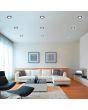 Trio Aura 652310132 sfeerfoto van negen zwarte inbouwspots met LED paneeltje en LED rand in een moderne woonkamer met witte hoekbank