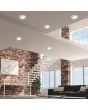 Trio Aura 652410106 sfeerfoto van zes chromen inbouwspots met LED paneeltje en LED rand om een grote woonkamer met vide