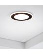 Trio Aura 652410132 sfeerfoto van mat zwarte inbouwspot met LED paneeltje en LED rand ingebouwd in een plafond