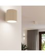 Sfeerfoto van Sollux Aura beige geribbeld cilindervormige wandlamp van 10 cm in hoogte met een G9 lampje erin in een woonkamer voor een plafondlamp uit dezelfde serie