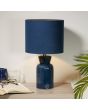Searchlight Ava EU62922BL sfeerfoto van blauwe tafellamp van 39cm hoog met flesvormige voet van keramiek en ronde kap van fluweel op een houten kastje met een opengeslagen boek met bril
