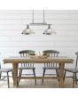 Searchlight Bistro 2682-2SS sfeerfoto van staal kleurige hanglamp met twee albast glazen kappen aan een dubbele stang boven een houten tafel met bakje met kaarsen en vier grijze stoelen