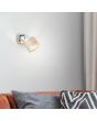Brilliant Alexia 99303/22 sfeerfoto van chromen spot met kapje van grijs textiel met chromen randen boven een rode bank