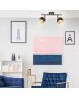 Brilliant Grove 99301/86 sfeerfoto van zwarte spot met twee spotjes met dubbele kap van zwart textiel en daarbinnen goudkleurig metaalgaas in woonkamer met blauwe stoel en bank