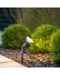 Sfeerfoto van Reality Caceres zwarte tuinspot van 52 cm hoog met E27 LED reflector lamp van 15w en een lumen output van 1500 in 4000K in een border met buxus planten