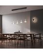 Trio Celeste 254910132 sfeerfoto van verchroomd glazen schijfvormige wandlamp in een moderne eetkamer met een hanglamp uit dezelfde serie boven de eettafel