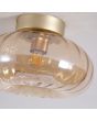Searchlight Celestial 32156-28GO detailfoto van de zijkant van de plafondlamp met goudkleurig plafondplaatje met 28cm grote kap van geribbeld amberkleurig glas