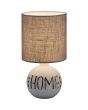 Trio Esna R50651025 tafellamp met beige voet met de tekst "home" en een bruine kap van textiel