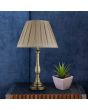 Searchlight Flemish EU4023AB sfeerfoto van bronzen tafellamp met sierlijke slanke voet en kap van geplooid grijs textiel op een donkere tafel met vetplant