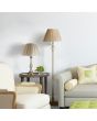 Searchlight Flemish EU5029AB sfeerfoto van antiek bronzen vloerlamp met ronde kap van geplooid grijs textiel naast een tafeltje met een tafellamp uit dezelfde serie in een sfeervolle woonkamer met beige bank en stoel