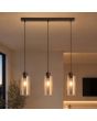 sfeerfoto van hanglamp met brons kleurige plafondbalk met een lengte van 60 cm en drie pendels met elk een kap van mat met helder gestreept amber kleurig glas met een diameter van 11cm
