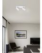 Trio Marley 802400201 sfeerfoto van witte spot met rechthoekige plafondplaat en twee cilindervormig spotjes met GU10 lamp in een moderne huiskamer met grijze bank en stoel voor een TV en schilderij