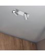 Trio Marley 802400207 sfeerfoto van staalkleurige spot met rechthoekige plafondplaat en twee cilindervormig spotjes met GU10 lampje aan een plafond voor een houten kastenwand