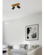 Trio Marley 812400232 sfeerfoto van spotje met rechthoekige houten plafondplaat en twee zwarte cilindervormige spotjes met GU10 lampje in een moderne woonkamer met witte hoekbank
