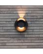 Sfeerfoto van Lutec Moov antraciet grijs schijfvormige wandlamp voor buiten met een diameter van 21,1 cm met lichtbundel naar boven en twee draaibare schijven met richtbare LED bundels