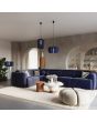 Sfeerfoto van Sollux Mula marine blauwe hanglamp met een diameter van 45 cm en voorzien van zestien 25 cm hoge lamellen van vilt in een woonkamer met andere lampen uit dezelfde serie