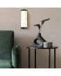 Searchlight Nile 10887BK sfeerfoto van badkamerlamp met kap van resin met marmerlook naast een groene stoel en bijzettafel met vaas