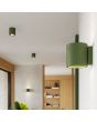 Sfeerfoto van Sollux Orbis olijfgroen betonnen cilindervormige wandlamp van 10cm hoog met up en down licht in een woonkamer met meerdere lampen uit dezelfde serie