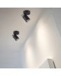 Trio Pago 803500132 sfeerfoto van twee zwarte wandspots van metaal met dieper liggende GU10 lamp die een wand uitlichten