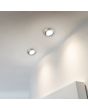 Trio Rila 650310107 sfeerfoto van twee staalkleurige kantelbare inbouwspots met geïntegreerde LED achter mat glas in een plafond, gericht tegen een muur