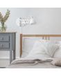 Sfeerfoto van Reality Scissor wandlamp met scharnierende chromen arm van 53cm en wit metalen kapje met E27 peertje boven een bed